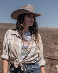 A woman in a checkered top and a Felt Cowboy Hat