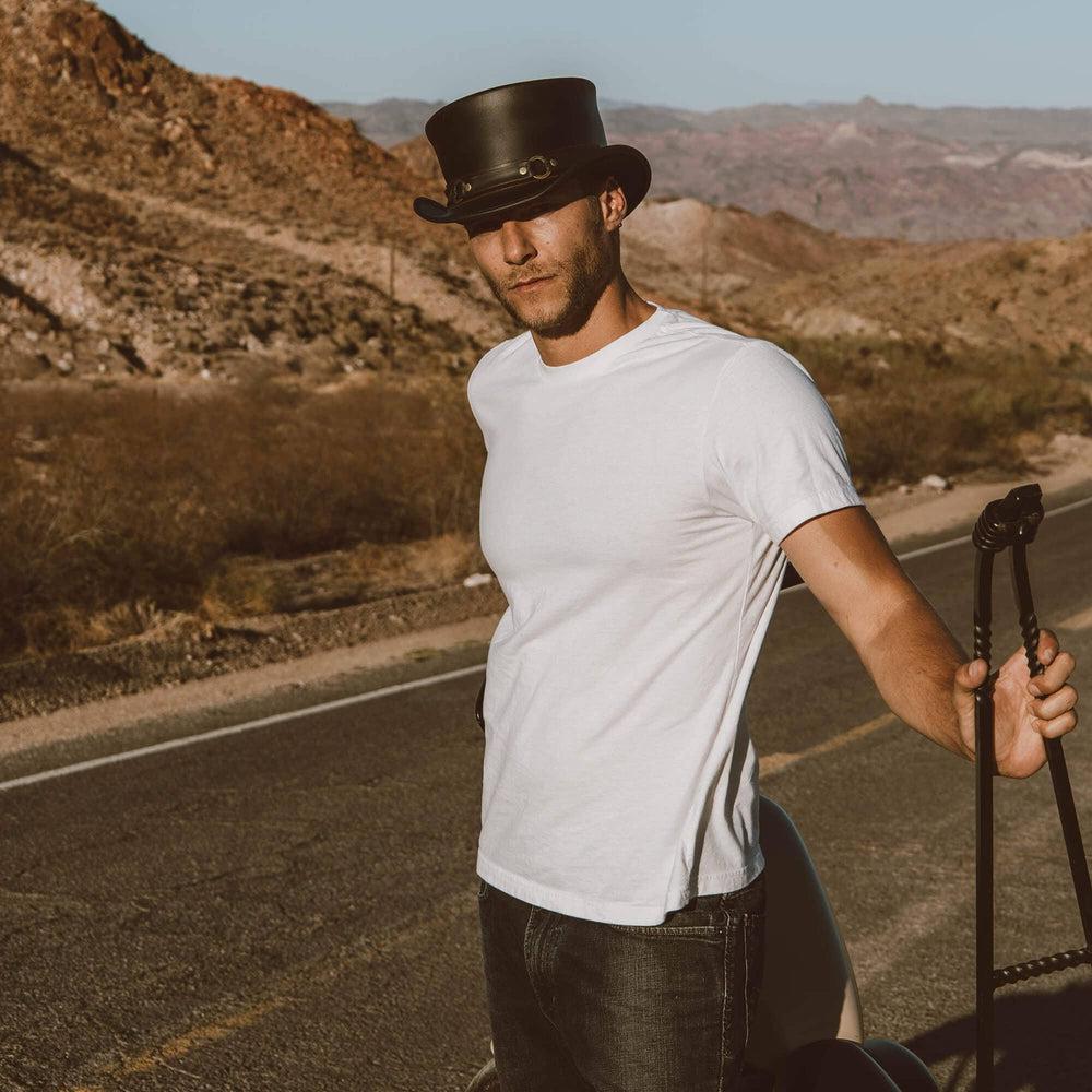 A man on the road wearing El Dorado Black Top Hat