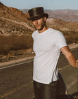 A man on the road wearing El Dorado Black Top Hat