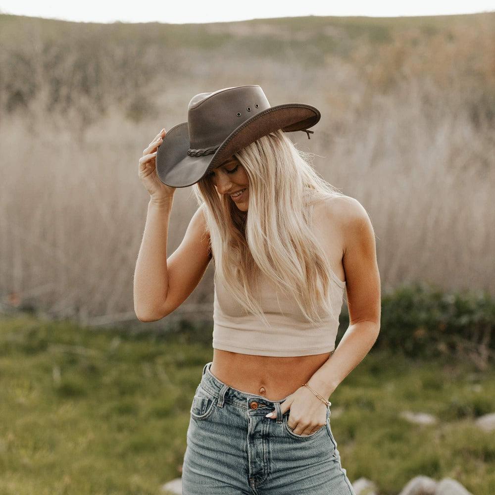 A woman standing outdoors wearing Brown Leather Cowboy Hat