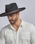 A man wearing Hudson Black Felt Fedora Hat on an angle view