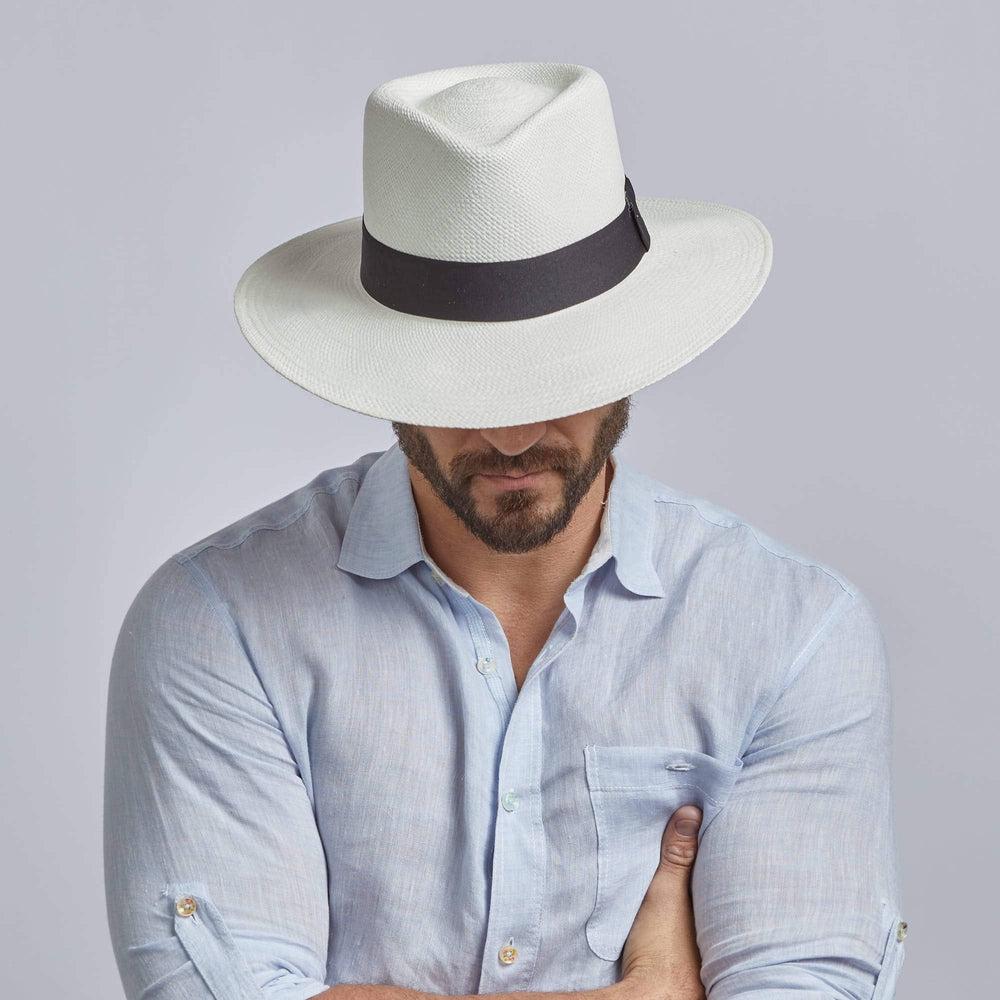 A man wearing White Panama Fedora Hat