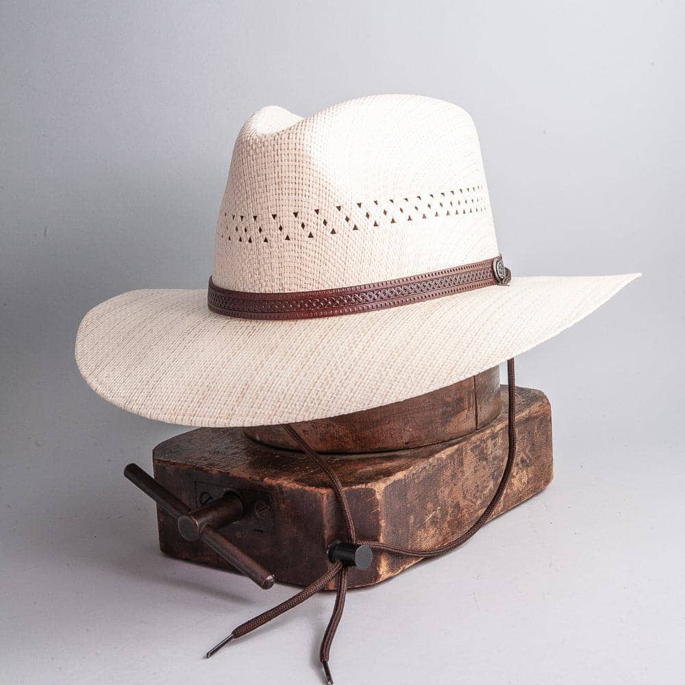 A side view of  Barcelona Wide Brim Natural Straw Sun Hat