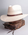 A side view of  Barcelona Wide Brim Natural Straw Sun Hat 