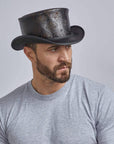 a man wearing the Royal Skull Leather Black Top Hat
