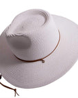 An angle view of Felix white straw sun hat with chinstrap