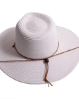 A top view of Felix white straw sun hat with chinstrap