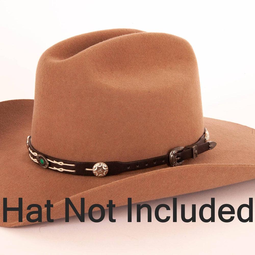 An angle view of a Friesian Whisperer Tooled Leather Cowboy Hat Band on a brown hat