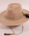 An angle view of a cream cowboy hat placed on a stand