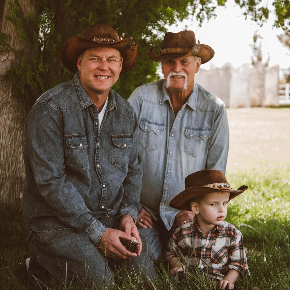 A family spending time outdoors wearing cowboy hats