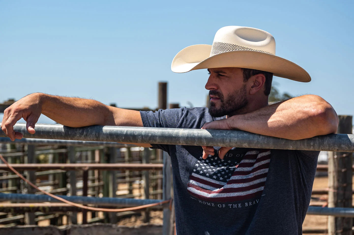 Cowboy leaning against fence while wearing the Big Sky mens cowboy hat by American Hat Makers