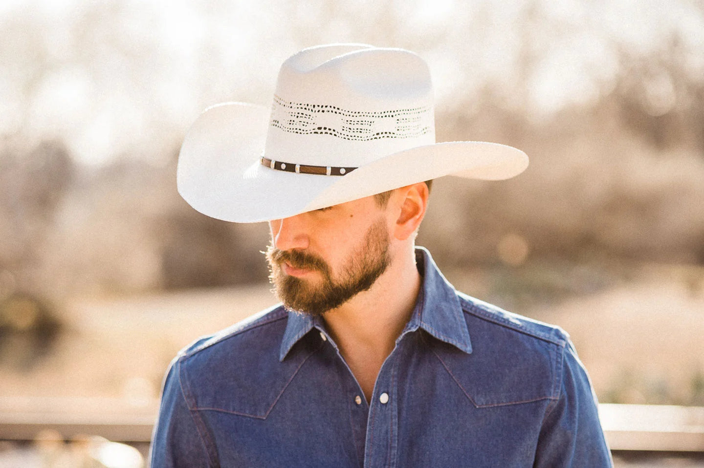 Cowboy posing wearing the Billings white cowboy hat by American Hat Makers