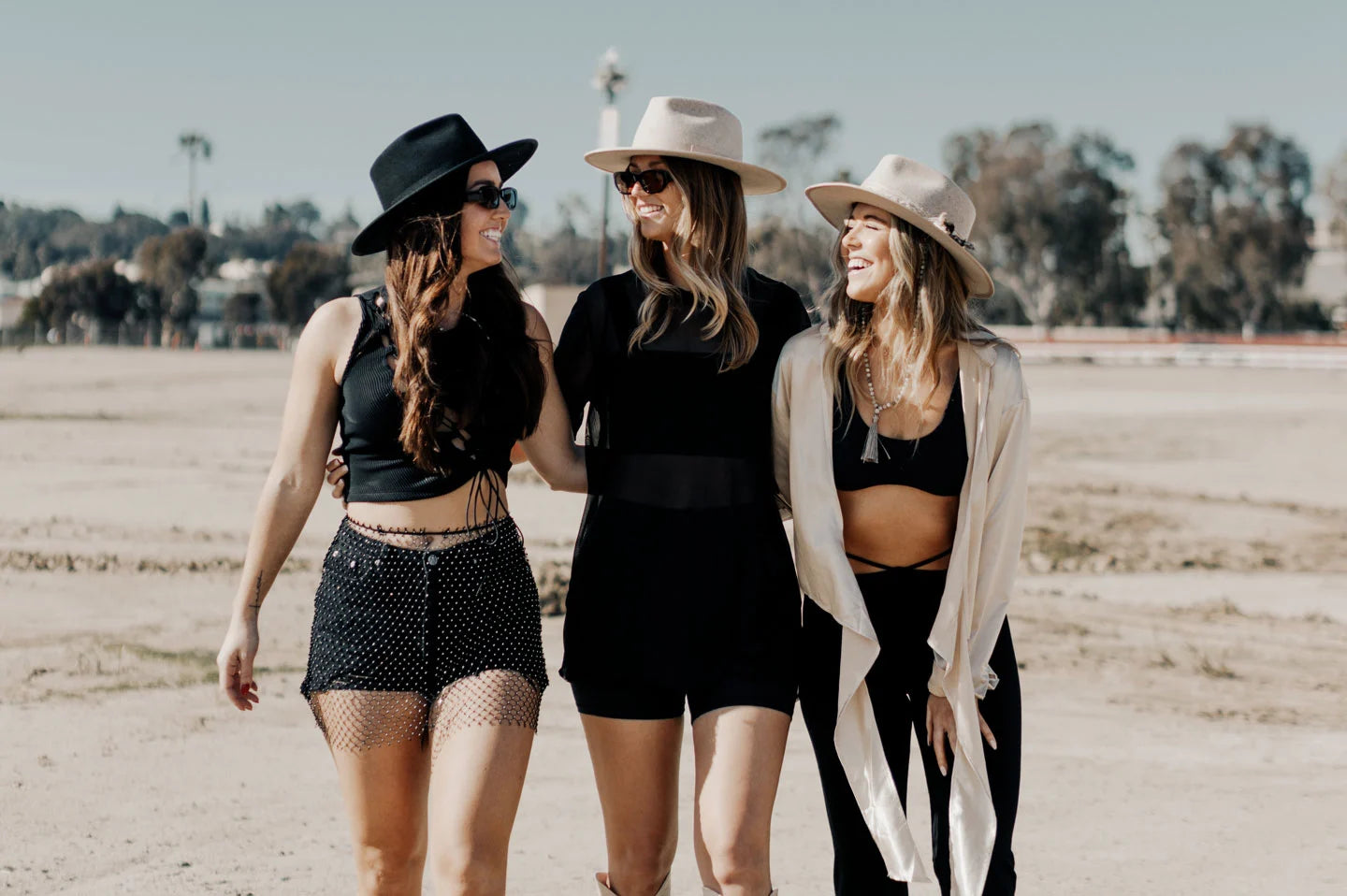 Three women standing in field wearing the Bondi and Moonshine festival hats by American Hat Makers