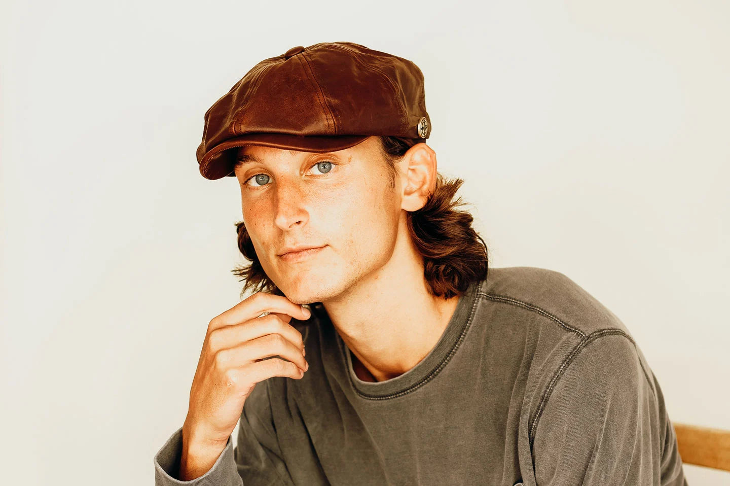 Man posing with the Bourbon St mens cap by American Hat Makers