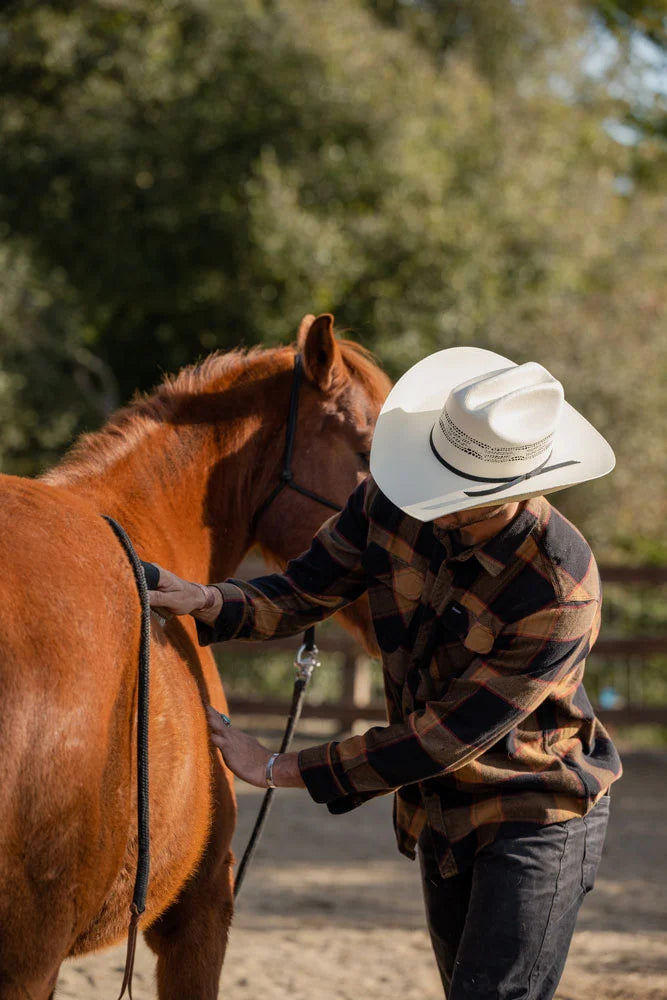 Man taking care of horse while wearing the Bozeman mens cowboy hat by American Hat Makers