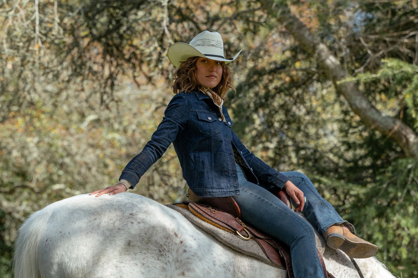 Woman sitting on horse wearing the Bozeman white cowboy hat by American Hat Makers
