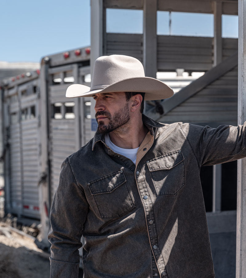 A man wearing a san felt cowboy hat