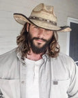 man in tan shirt with a beard wearing a diego palm cowboy hat