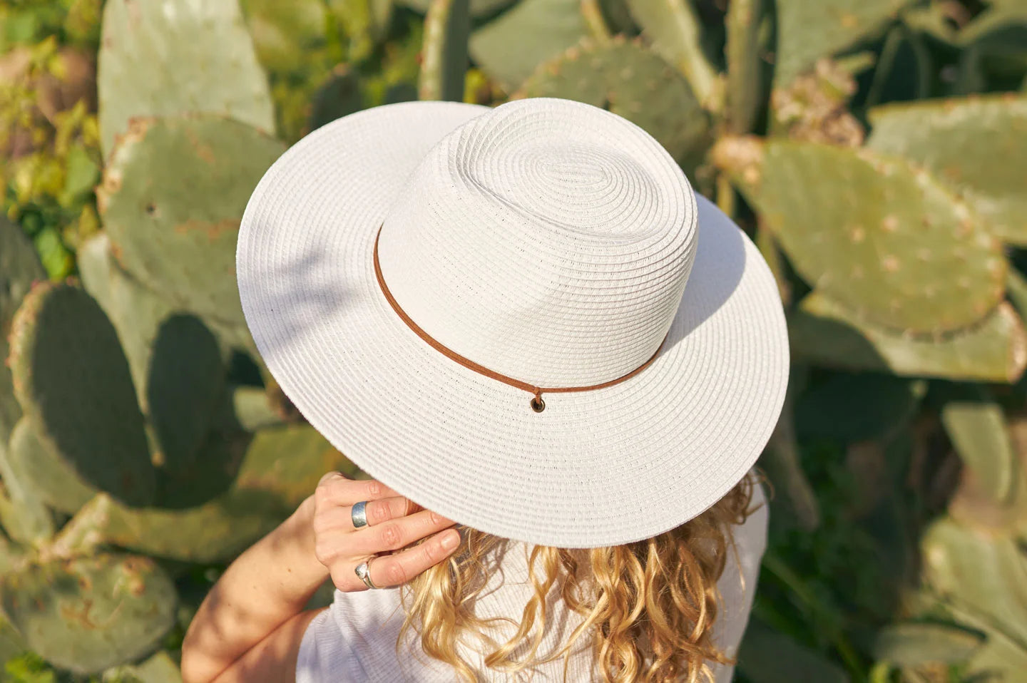 Woman standing next to cactus wearing the Felix womens wide brim hat by American Hat Makers