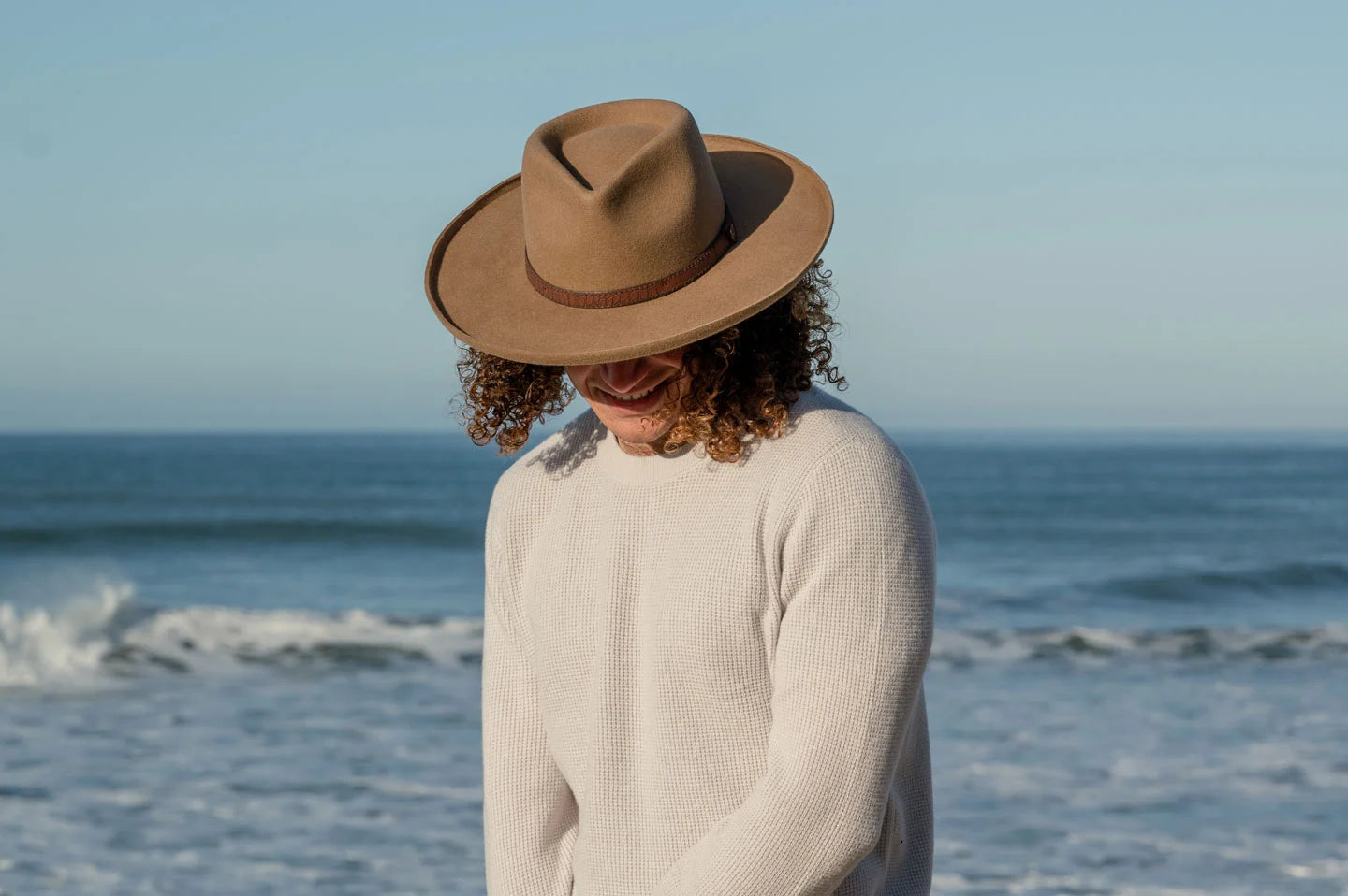 Man at beach while wearing the hudson bark felt fedora hat by American Hat Makers