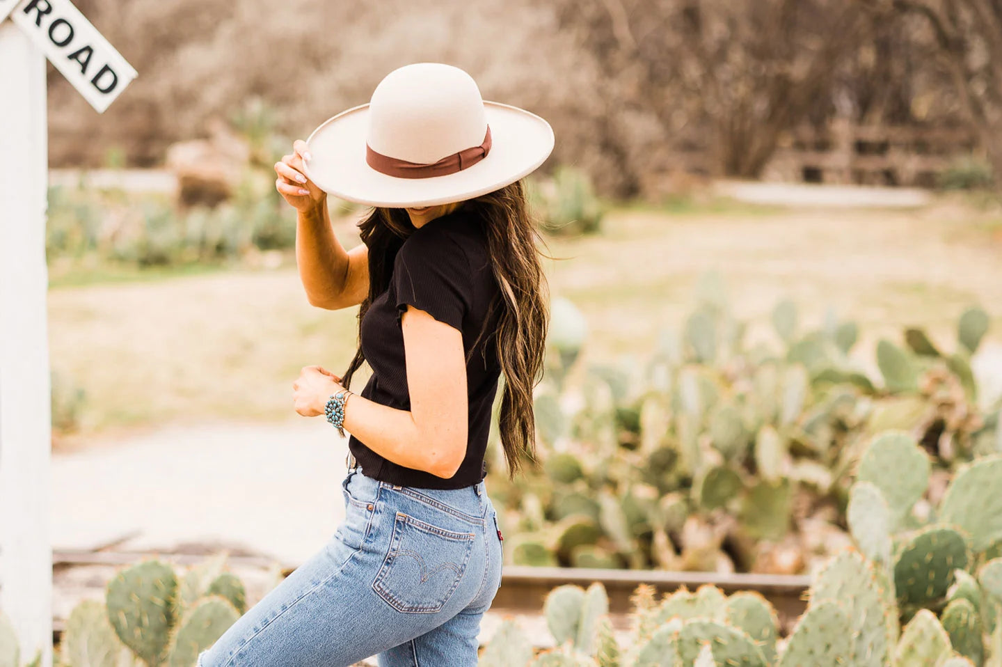 Woman in cactus field with the Josey felt cowboy hat by American Hat Makers