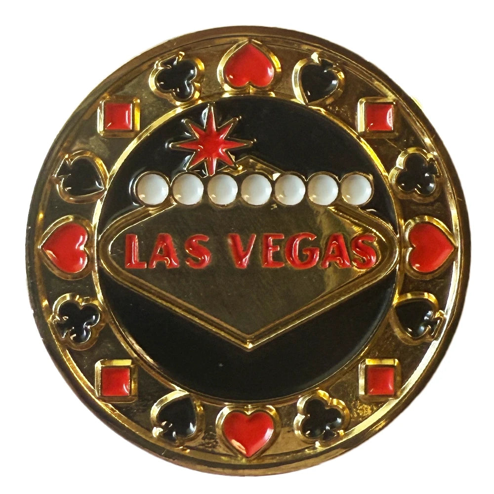 A circular gold and black Las Vegas casino-themed pin or badge featuring the word 'LAS VEGAS' in red, playing card suit symbols, and white dots on a black center, isolated on a white background.