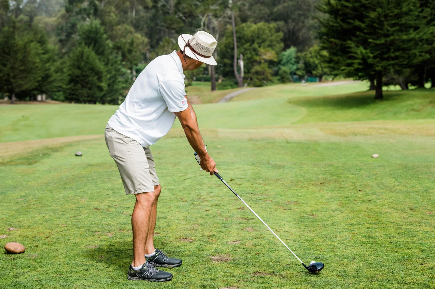 Man golfing while wearing the Milan mens hat by American Hat Makers