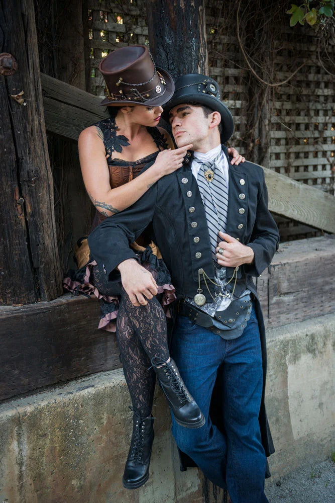 A woman sitting on a ledge wearing a brown hat and a man leaning on her wearing a coat and black top hat