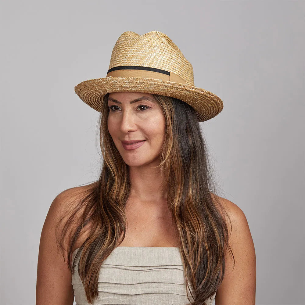 Woman with dark hair wearing a Sawyer Straw Hat and a beige top.