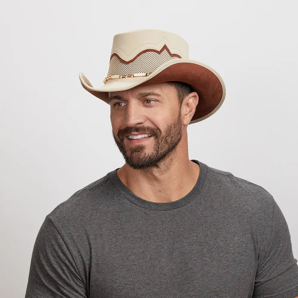 Man with a beard wearing a Sierra Latte Cowboy Hat and a gray t-shirt, looking off to the side.