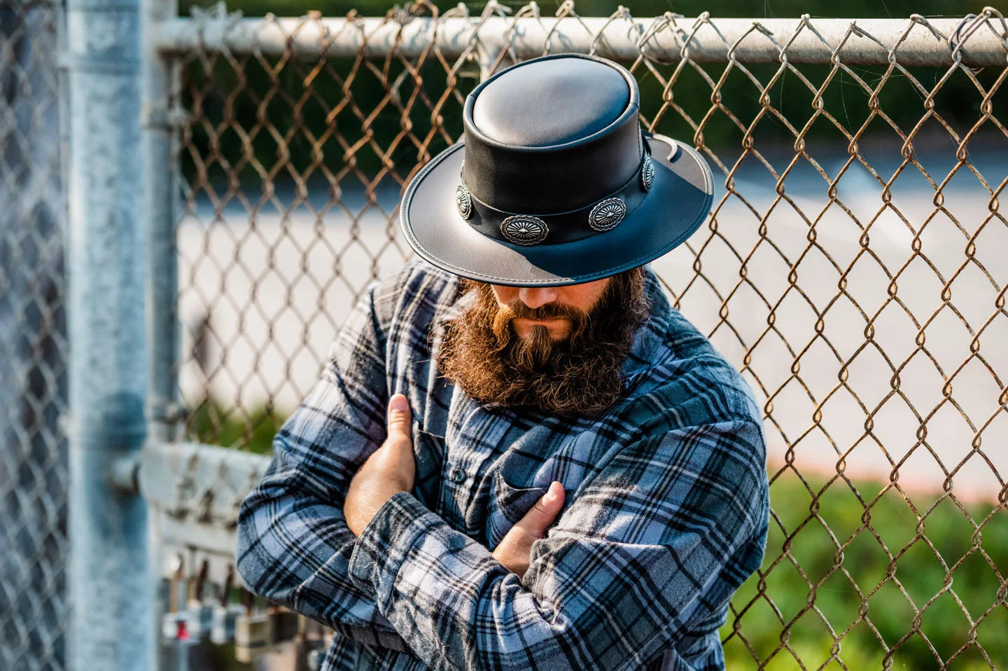 Man leaning on fence wearing the Silverado mens pork pie hat