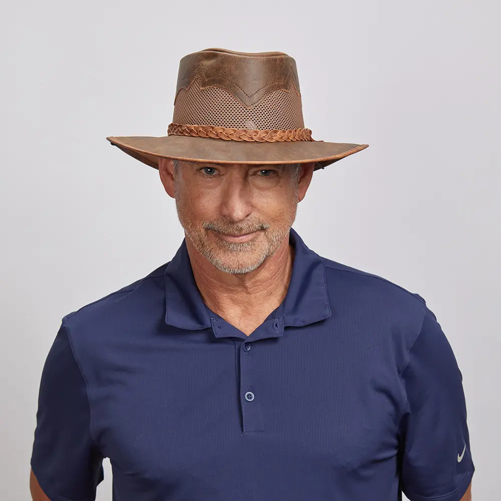 Middle-aged man with a light beard wearing a Sirocco Copper Outback Hat and a navy blue polo shirt.