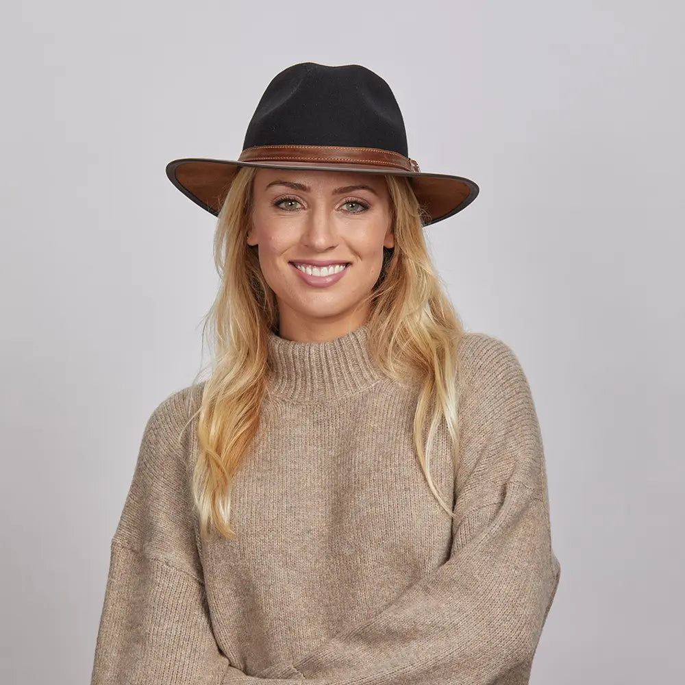 Smiling woman wearing a beige turtleneck sweater and a Coal Felt Fedora Hat.