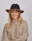 Smiling woman wearing a beige turtleneck sweater and a Coal Felt Fedora Hat.