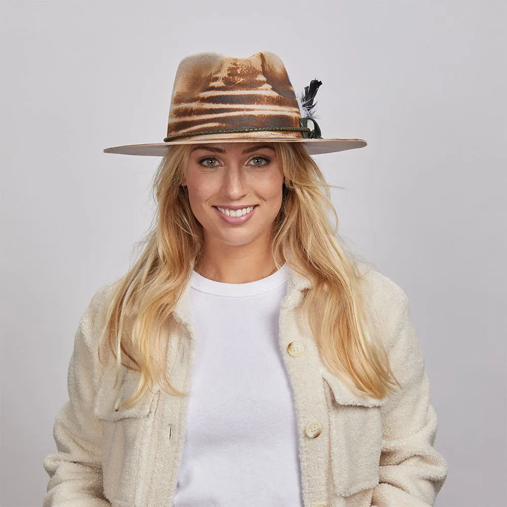 A woman wearing a white shirt paired with a textured beige jacket and the Tornado Fedora Hat