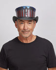 A man wearing a black shirt and the USA Black Leather Top Hat