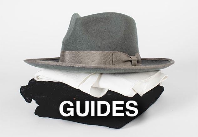 A pile of clothes with a gray felt hat on top