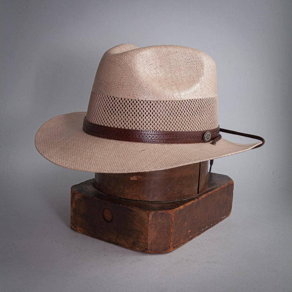 A side view of Milan Tan Straw Fedora Hat placed on a stand