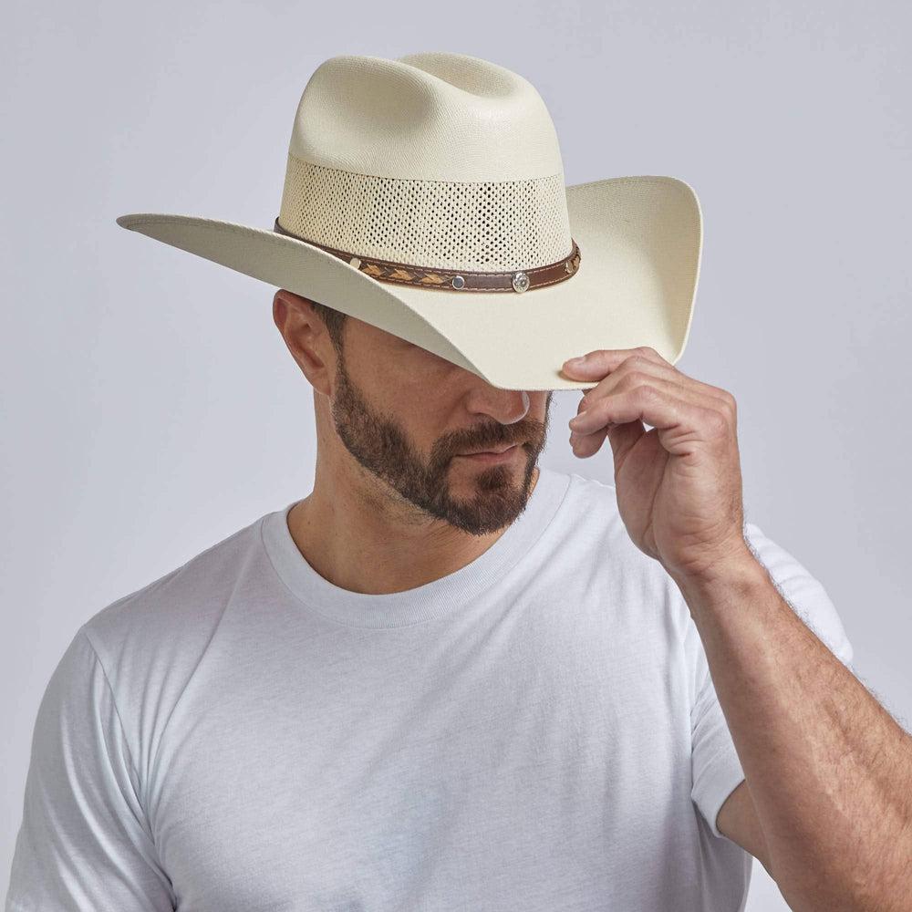 A man wearing Cream Straw Cowboy Hat on an angle view