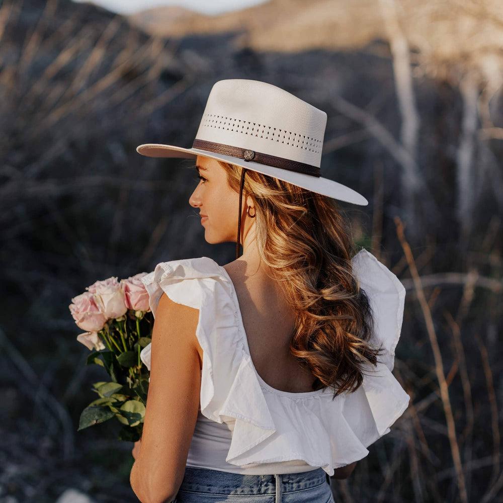 A woman wearing Cream Straw Sun Hat on a back view