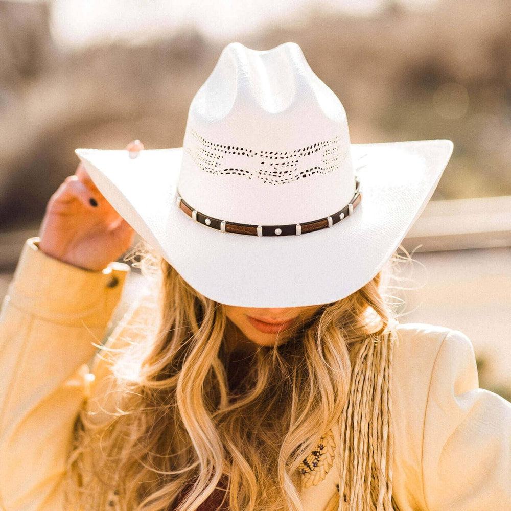 A woman with blonde hair wearing Billings Cream Straw Cowboy Hat