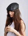 A woman wearing Leather Black Flat Cap on an angle view