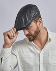 A man wearing Bookie Black Leather Cap for Men 