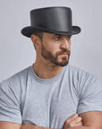 A man wearing Unbanded Bromley Black Leather Top Hat on a side view
