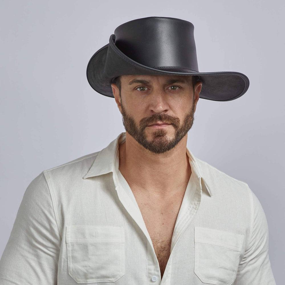 A man wearing Unbanded Black Leather Cavalier Hat 
