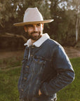 A man in a denim jacket wearing Crescent Oatmeal Felt Wool Fedora Hat 