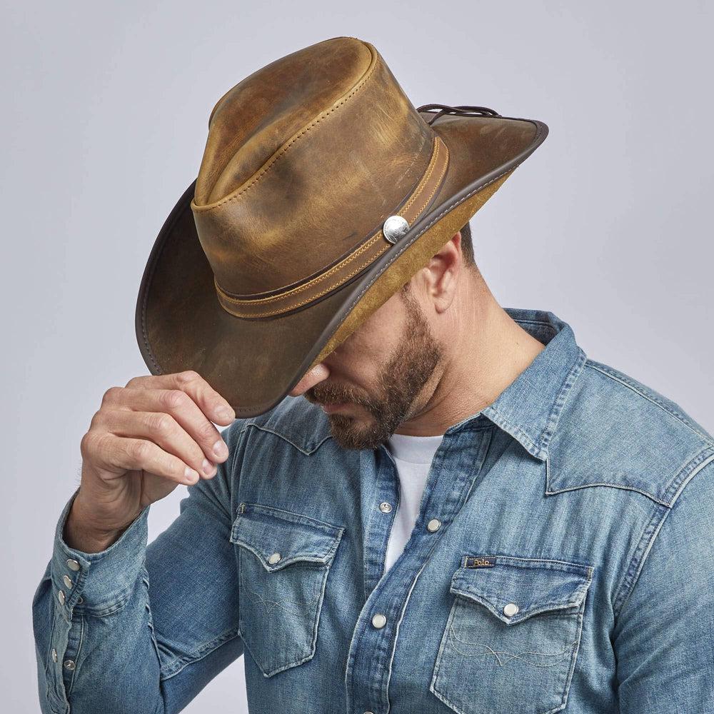 A man in denim jacket wearing Cyclone Burnt Honey Leather Cowboy Hat 