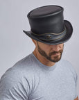 A man wearing El Dorado Black Leather Top Hat with Eye Band on an angle view