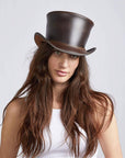 A woman wearing Unbanded El Dorado Brown Leather Top Hat on front view