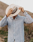 A man wearing stripes and a Florence Cream Straw Sun Hat
